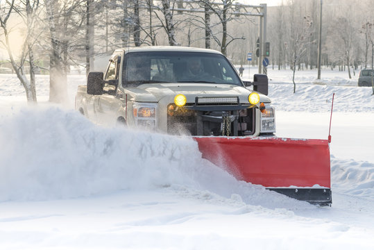 white ford snow plowing