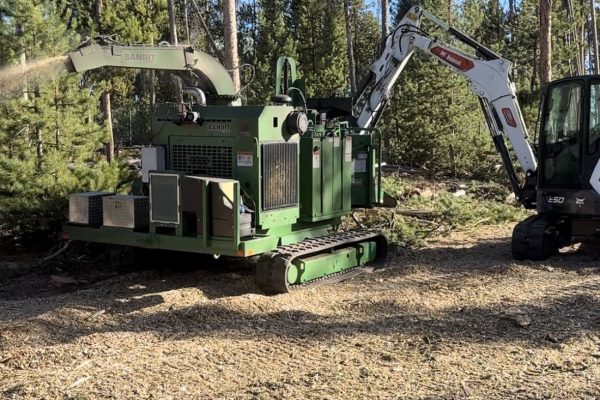 Bandit tracked chipper & Bobcat E50 performing land clearing services for fire mitigation.